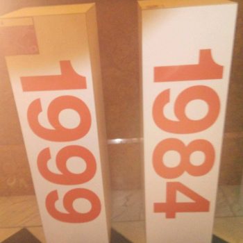 Two tall rectangular trade show display towers with large orange numbers in Chicago Downtown.