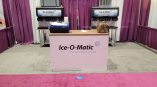 Tradeshow fabric counter display with printed graphics and backdrop curtains in Chicago Downtown.