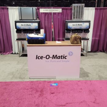 Tradeshow fabric counter display with printed graphics and backdrop curtains in Chicago Downtown.