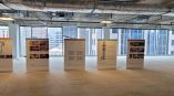 Five retractable vinyl banner stands with informational graphics displayed inside an unfinished