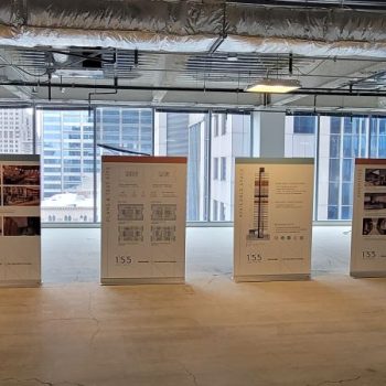 Five retractable vinyl banner stands with informational graphics displayed inside an unfinished