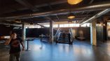 Two pillar wraps with geometric designs and text in an industrial event space in Chicago Downtown.