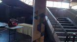 Column wrap with geometric pattern signage in an industrial space near a staircase in Chicago