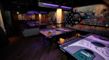 Indoor event space with custom printed ping pong table graphics and wall murals in Chicago Downtown.