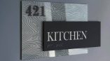 Rectangular layered ADA kitchen room sign with Braille on patterned acrylic in Chicago Downtown.