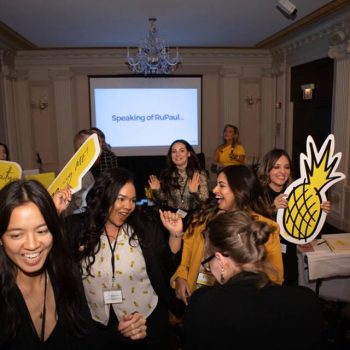 Indoor event room with a projector screen and foam board signs in Chicago Downtown.