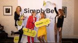 Large fabric event backdrop banner with printed logo and graphics held by four women in Chicago