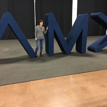 Large freestanding fabric-covered foam letters and arrow tradeshow display in Chicago Downtown.
