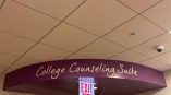 Curved vinyl wall sign above double doors in an indoor hallway in Chicago Downtown.