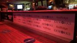 Event vinyl banner attached to a bar front with floor decals in Chicago Downtown.