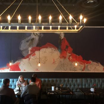 Large fabric canvas wall sign with artwork of a woman in red dress in Chicago Downtown.