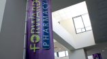 Indoor fabric banner with grommets and pole mount hanging in a building lobby in Chicago Downtown.