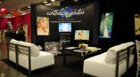 Curved fabric tradeshow display with mounted photo prints and TV screen in Chicago Downtown.