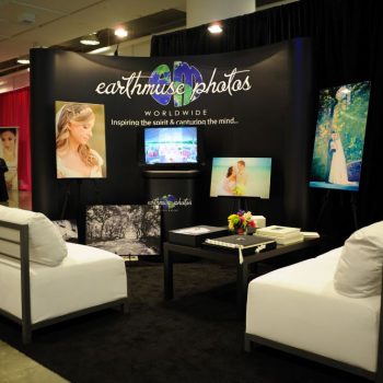 Curved fabric tradeshow display with mounted photo prints and TV screen in Chicago Downtown.