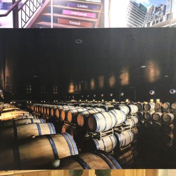 Large canvas print of wooden barrels stacked in a dark cellar displayed in Chicago Downtown.