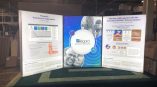 Three-panel illuminated fabric tradeshow display with graphics and text in Chicago Downtown.