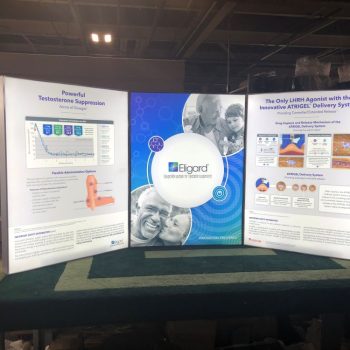 Three-panel illuminated fabric tradeshow display with graphics and text in Chicago Downtown.