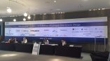 Large fabric event banner with sponsor logos hanging on a wall in Chicago Downtown.