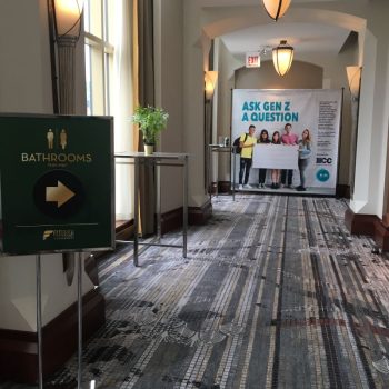 Freestanding metal sign with directional bathroom graphics and fabric tradeshow display in Chicago