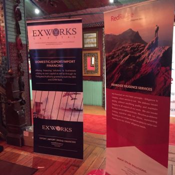 Two retractable vinyl banner stands displayed indoors on wooden floor in Chicago Downtown.