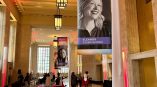 Indoor fabric hanging banners with portraits and text mounted on poles in Chicago Downtown.