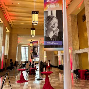 Indoor fabric hanging banners with portraits and text mounted on poles in Chicago Downtown.