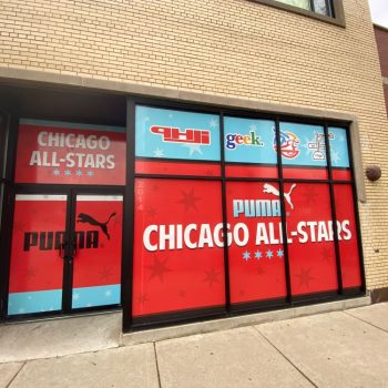 Window graphics with red and blue design covering storefront glass in Chicago Downtown.