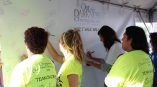 Large vinyl event banner with handwritten messages and signatures in Chicago Downtown.