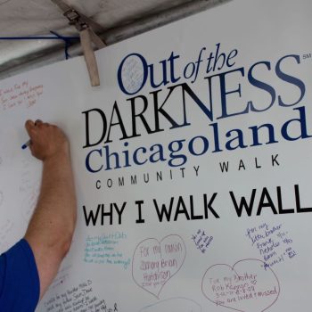 Large printed vinyl event sign with handwritten messages for community walk in Chicago Downtown.