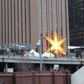 Large illuminated star-shaped event sign mounted on a building in Chicago Downtown.