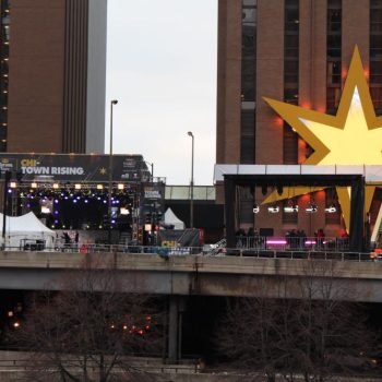 Outdoor event stage with truss banner and large illuminated star wall sign in Chicago Downtown.