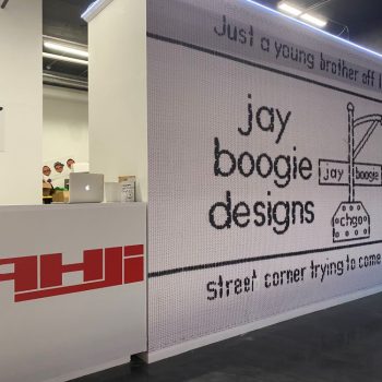 Large black and white wall mural with pixelated text and streetlamp graphic in Chicago Downtown.