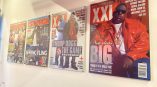 Four large acrylic wall signs featuring magazine covers mounted on a white wall in Chicago Downtown.