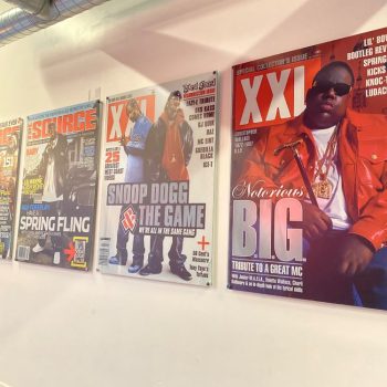 Four large acrylic wall signs featuring magazine covers mounted on a white wall in Chicago Downtown.