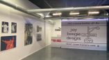 Large fabric event backdrop with printed graphics and mounted photo prints on white wall in Chicago