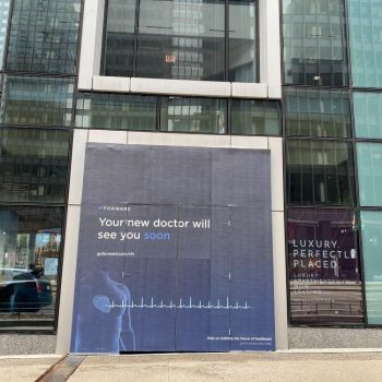 Large printed vinyl construction wall sign with medical graphics on building facade in Chicago