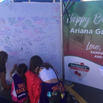 Large event banner with handwritten messages and a printed vinyl sign in Chicago Downtown.