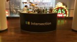 Curved fabric trade show counter with printed graphics and bottles on top in Chicago Downtown.