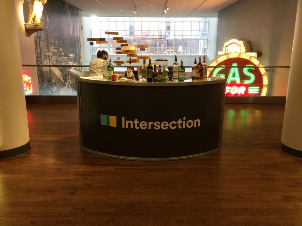 Curved fabric trade show counter with printed graphics and bottles on top in Chicago Downtown.