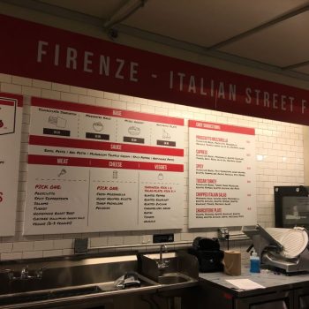 Indoor fabric banner and printed canvas menu signs above a food counter in Chicago Downtown.