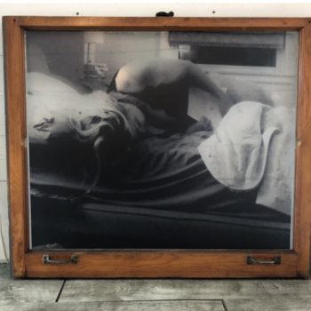 Framed black and white photographic print on wood displayed indoors in Chicago Downtown.