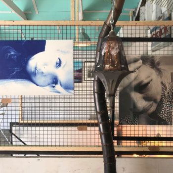 Two artistic photo prints mounted on wire mesh grid panels with wood framing in Chicago Downtown.