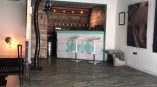 Indoor wooden bar with painted wall sign and large photographic prints in Chicago Downtown.