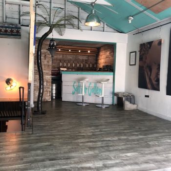 Indoor wooden bar with painted wall sign and large photographic prints in Chicago Downtown.