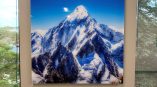 Mounted acrylic wall sign with a snow-covered mountain image between windows in Chicago Downtown.