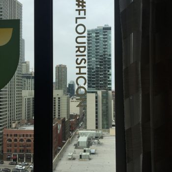 Vertical window graphic decal with hashtag text on glass overlooking Chicago Downtown.