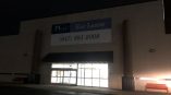 Large vinyl banner mounted above the entrance of a commercial building in Chicago Downtown.