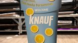 Freestanding tradeshow display shaped like a beverage cup with lemon graphics in Chicago Downtown.