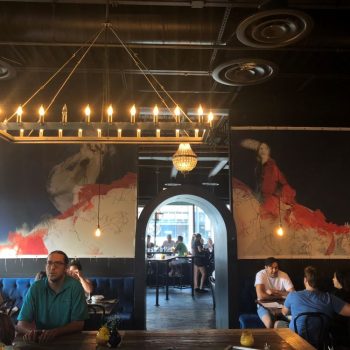 Two large canvas wall signs with abstract art in a restaurant interior in Chicago Downtown.