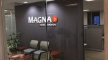 Interior office with acrylic wall sign mounted on a dark gray wall in Chicago Downtown.